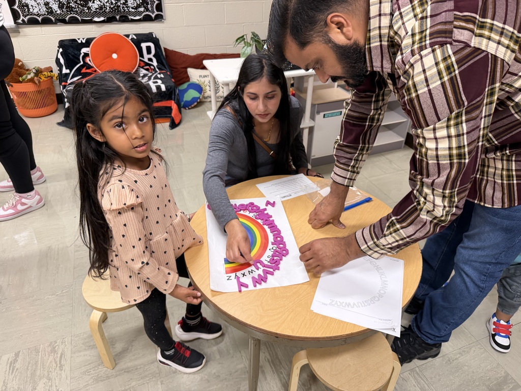 Kindergarten students and their families participate in hands-on literacy activities during Fall Family Literacy Night at Howland Springs Primary School.
