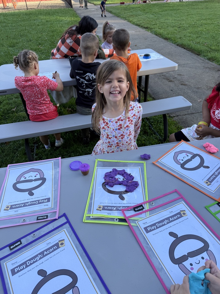 Howland Springs preschool children participate in outdoor storybook activities inspired by The Acorn and the Oak, exploring letters, acorns and tree growth.
