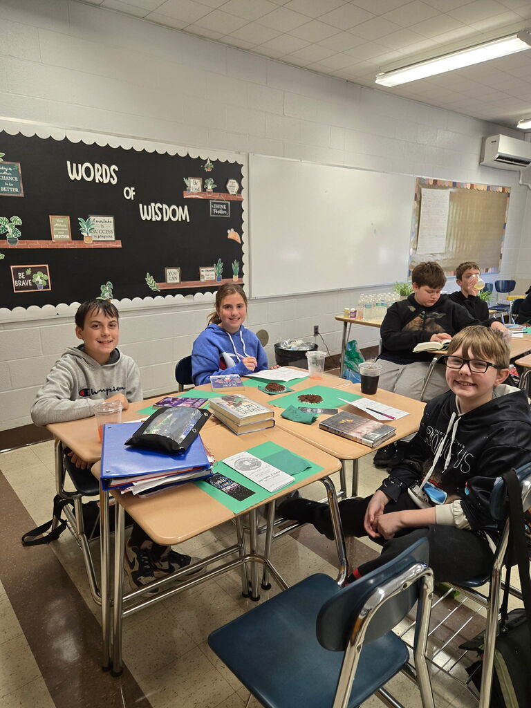 Howland Intermediate School sixth-grade students in Mrs. Olesky and Miss Less’ class preview books and enjoy drinks during their Starbooks Café activity in ELA.