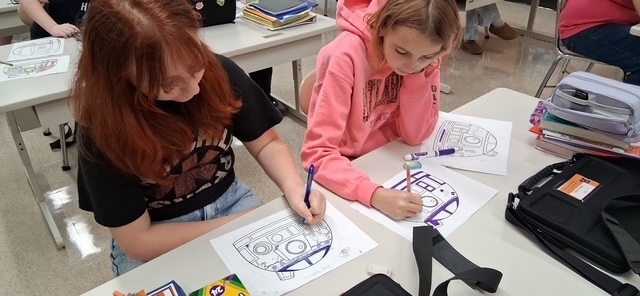 Howland Intermediate School students participate in Ohio Code Scholar, with Kenley and Ryeliegh working on Arduino wiring and audio while classmates develop ideas for 3D designs.
