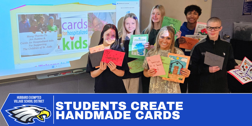 Hubbard High School Career and Community students hold handmade cards created for hospitalized children featuring colorful drawings, characters, and encouraging messages.