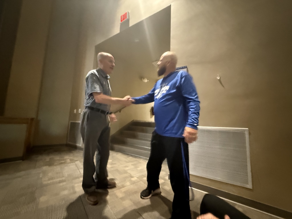 Hubbard Schools baseball coach John Schiraldi stands with a baseball or team setting, recognized for earning his 200th career victory.