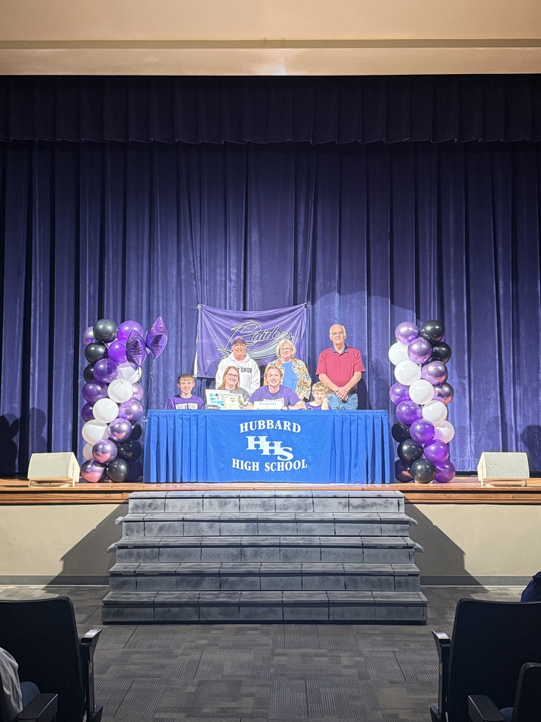 Joe Patrick: Student-athlete signing a letter of intent for swimming at Mount Union, seated at a table with supporters standing behind.