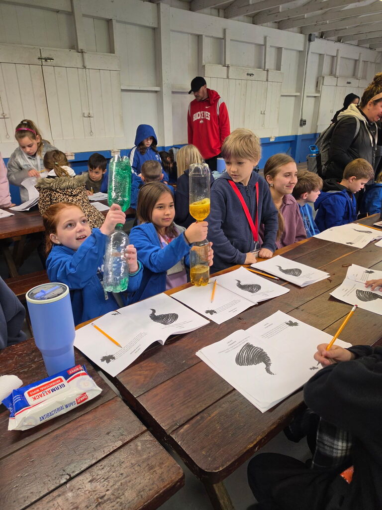 Hubbard second grade students participate in outdoor science activities at Harding Park with help from high school Ecology Club students.