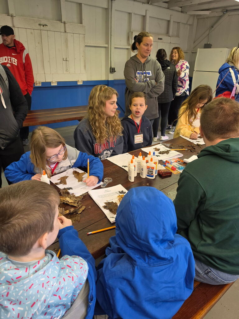 Hubbard second grade students participate in outdoor science activities at Harding Park with help from high school Ecology Club students.