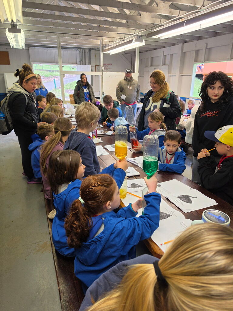 Hubbard second grade students participate in outdoor science activities at Harding Park with help from high school Ecology Club students.