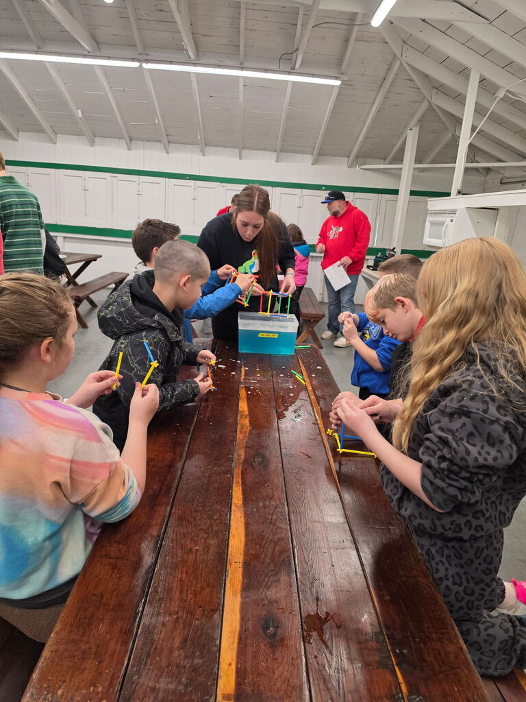 Hubbard second grade students participate in outdoor science activities at Harding Park with help from high school Ecology Club students.