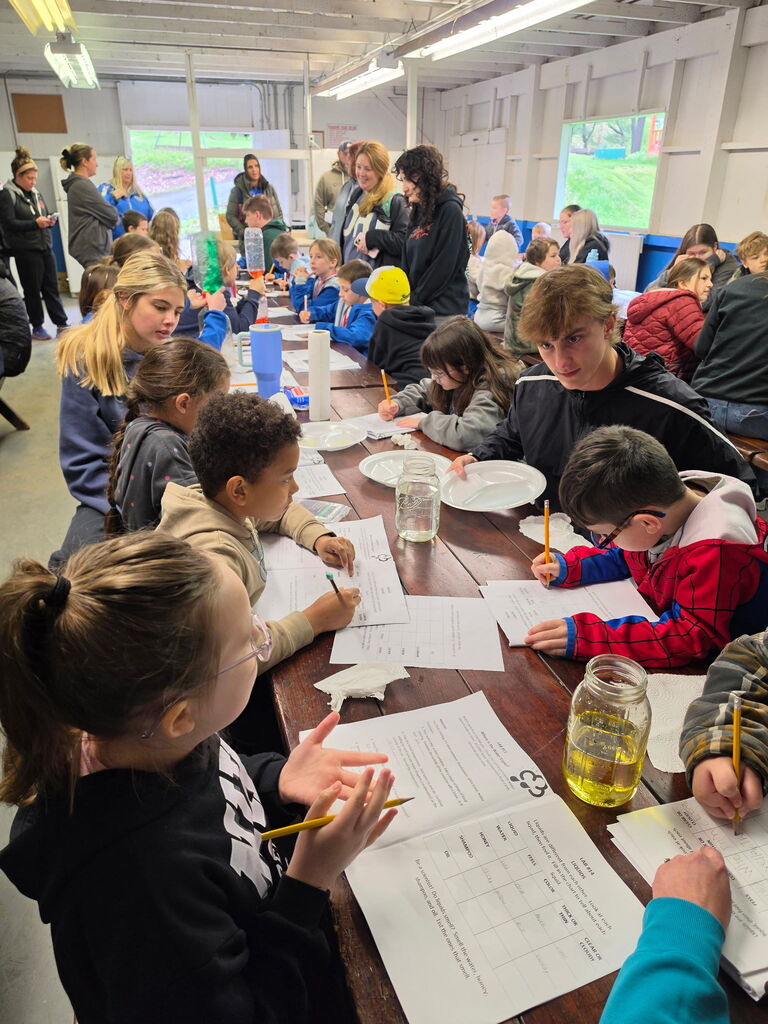 Hubbard second grade students participate in outdoor science activities at Harding Park with help from high school Ecology Club students.