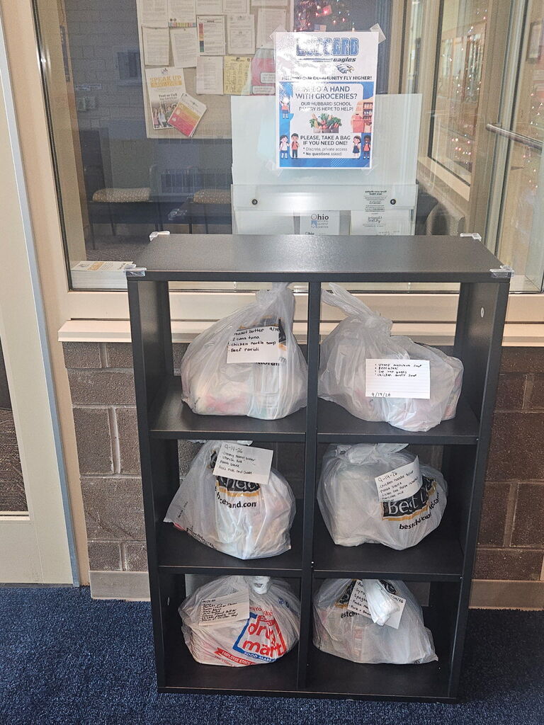 Grab-and-go food bags available for families at Hubbard Schools Pantry pickup stations near elementary and middle school entrances.