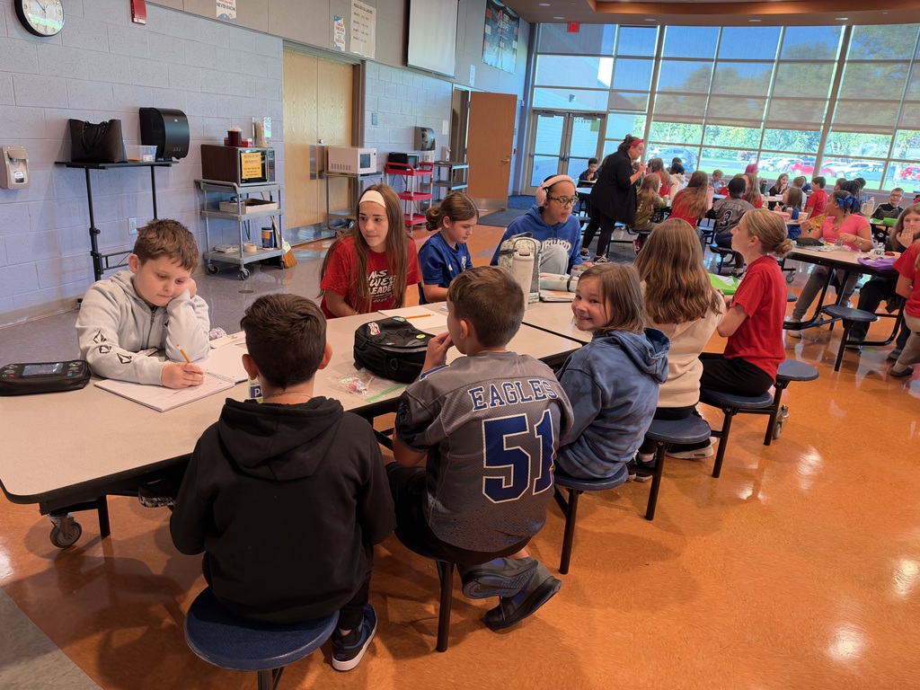 8th-grade WEB Leaders meet with their 5th-grade buddies during a first-month middle school check-in.