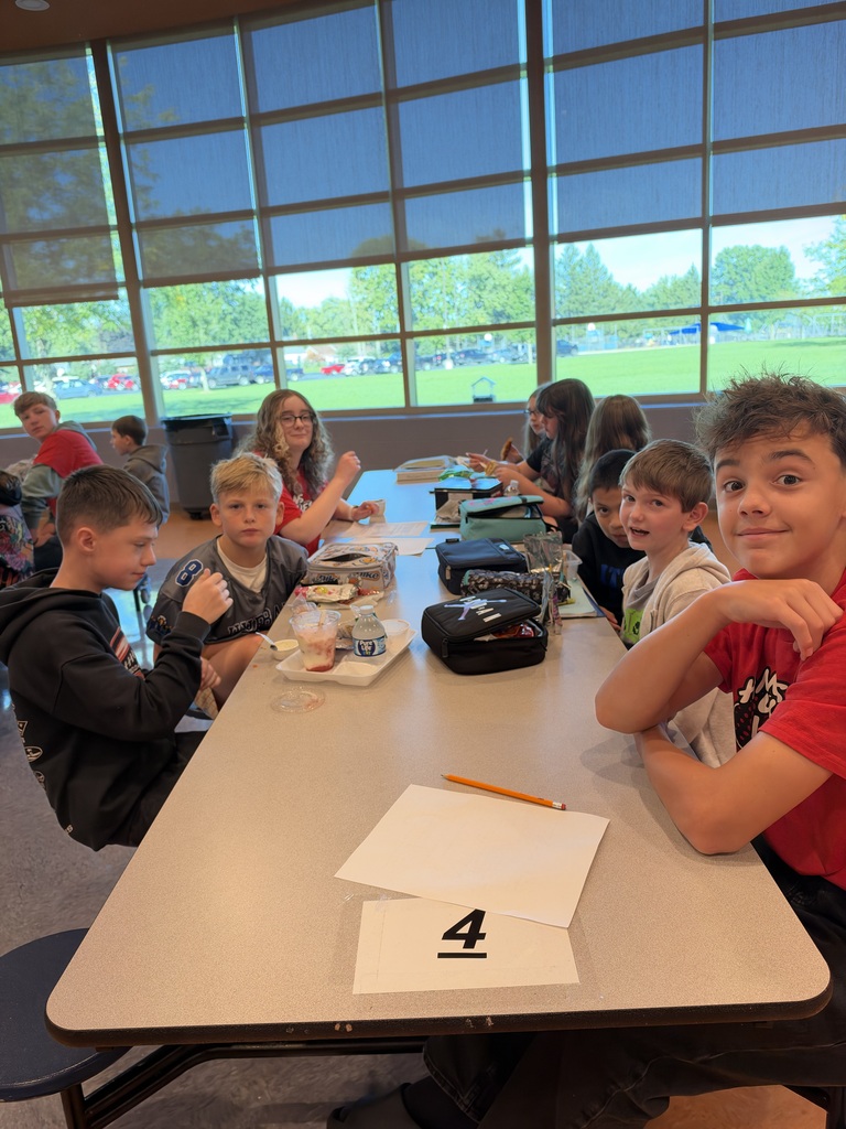 8th-grade WEB Leaders meet with their 5th-grade buddies during a first-month middle school check-in.