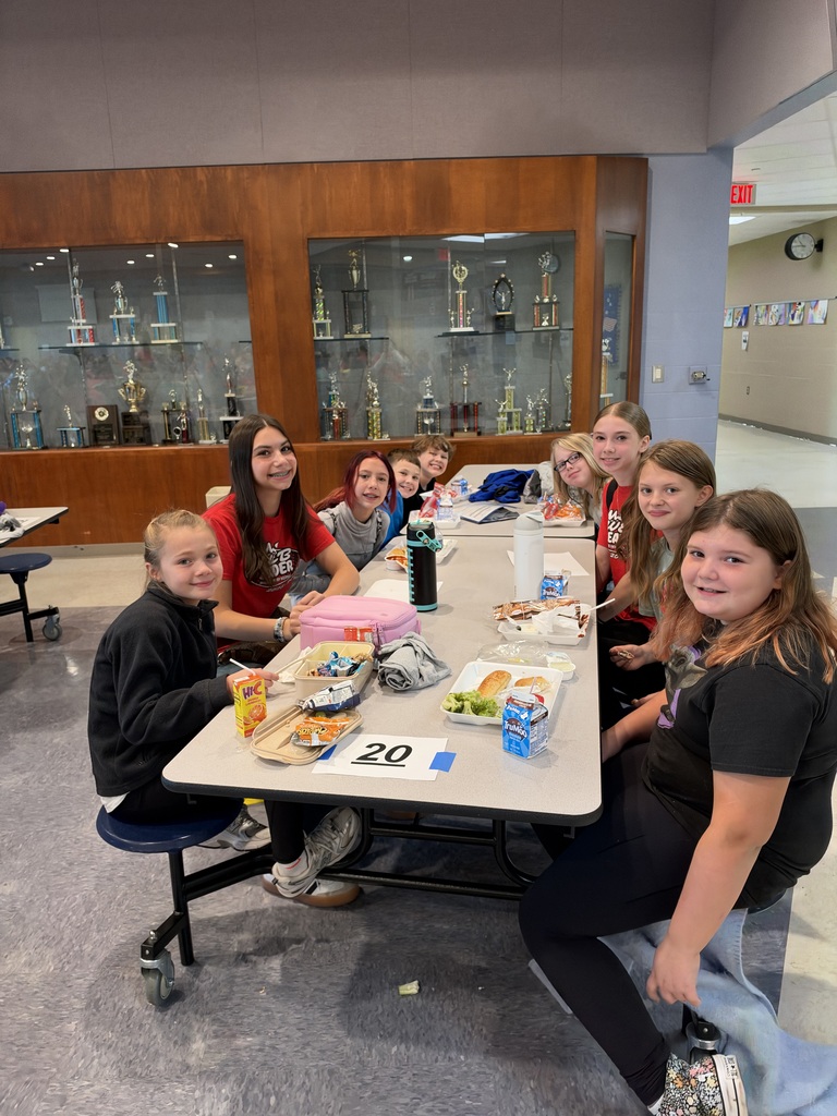 8th-grade WEB Leaders meet with their 5th-grade buddies during a first-month middle school check-in.