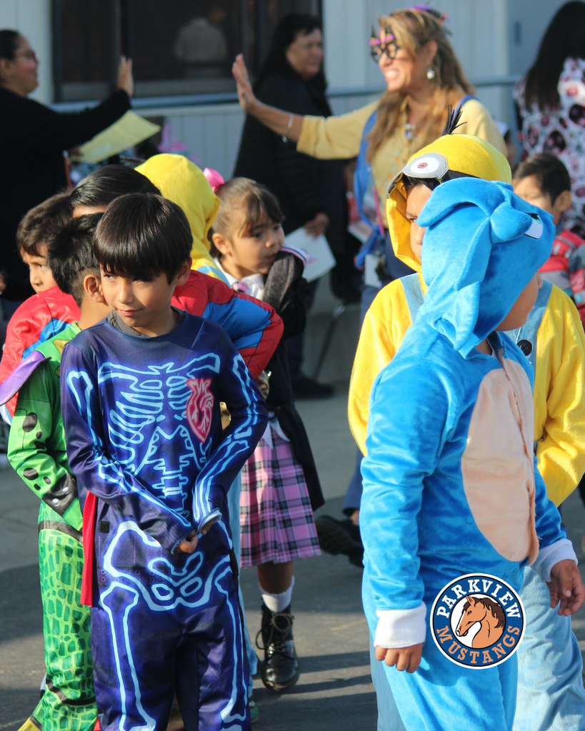 kids dressed in costumes celebrating Halloween