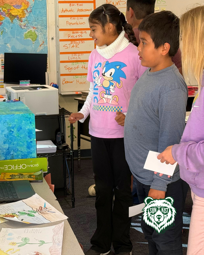 students  viewing projects and smiling