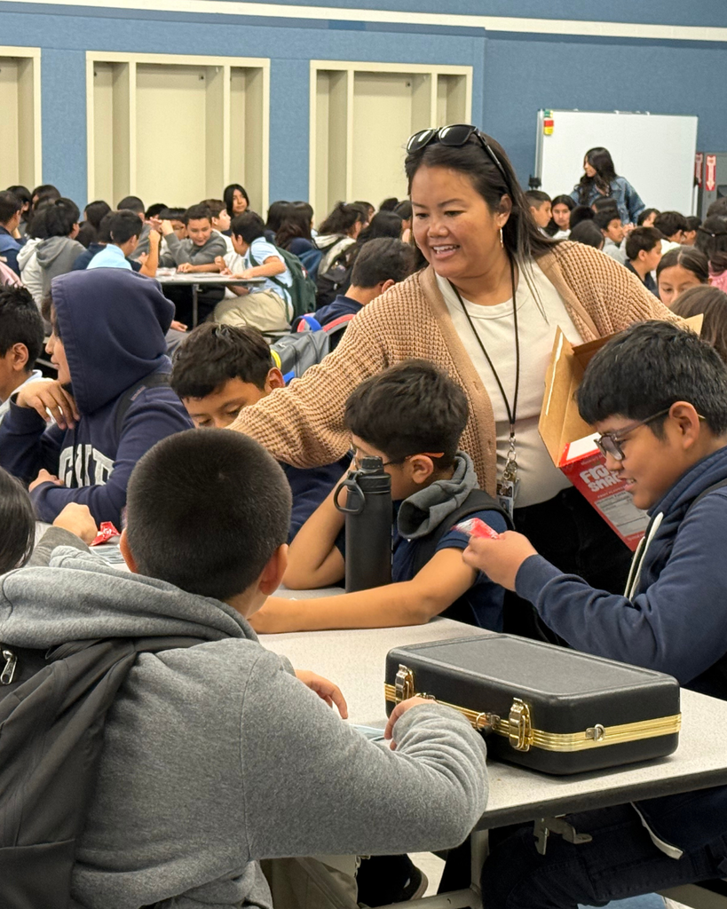 teacher smiling while 6th grader playing bingo
