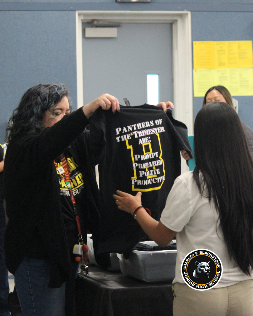 teacher giving student tshirt