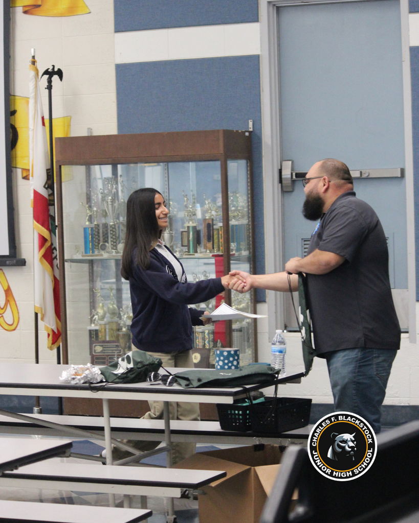 teacher shaking student hand accomplished