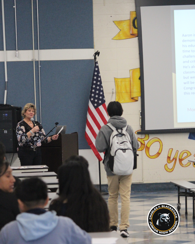 student walking to accept award