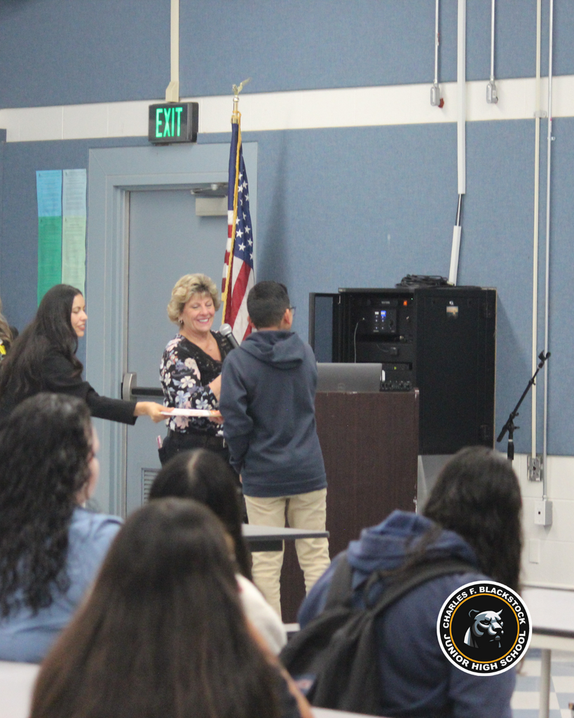 student walking to accept award