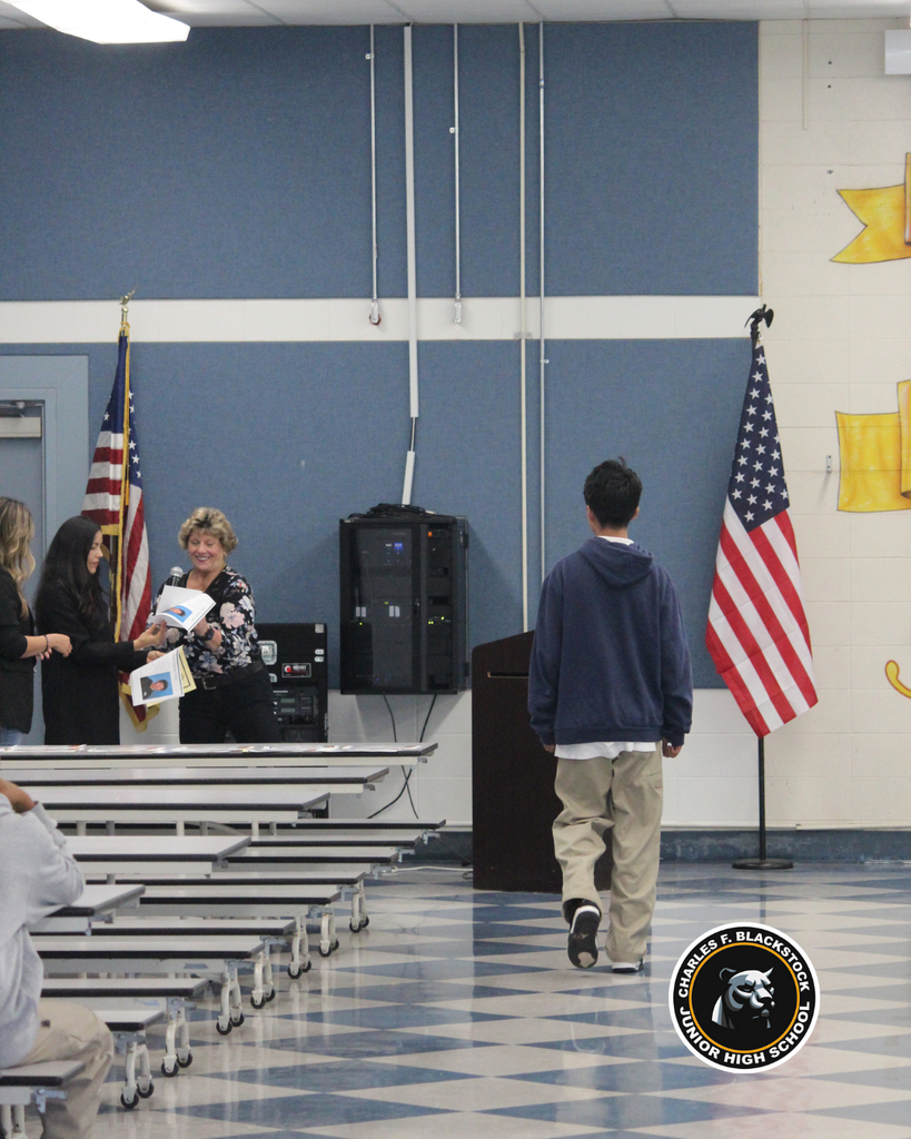 student walking to accept award