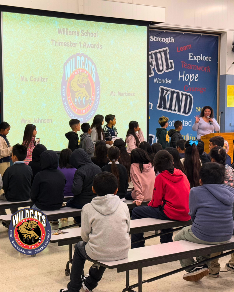 teacher speaking to students at award ceremony
