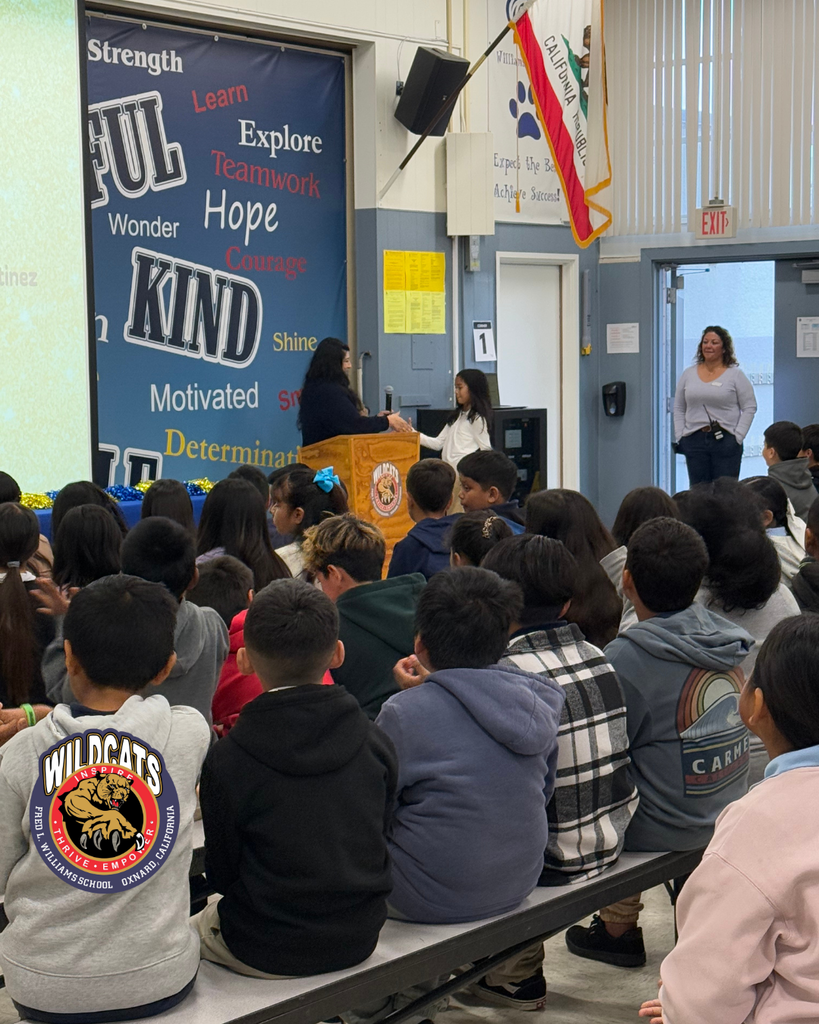 student walking to accept award from teacher