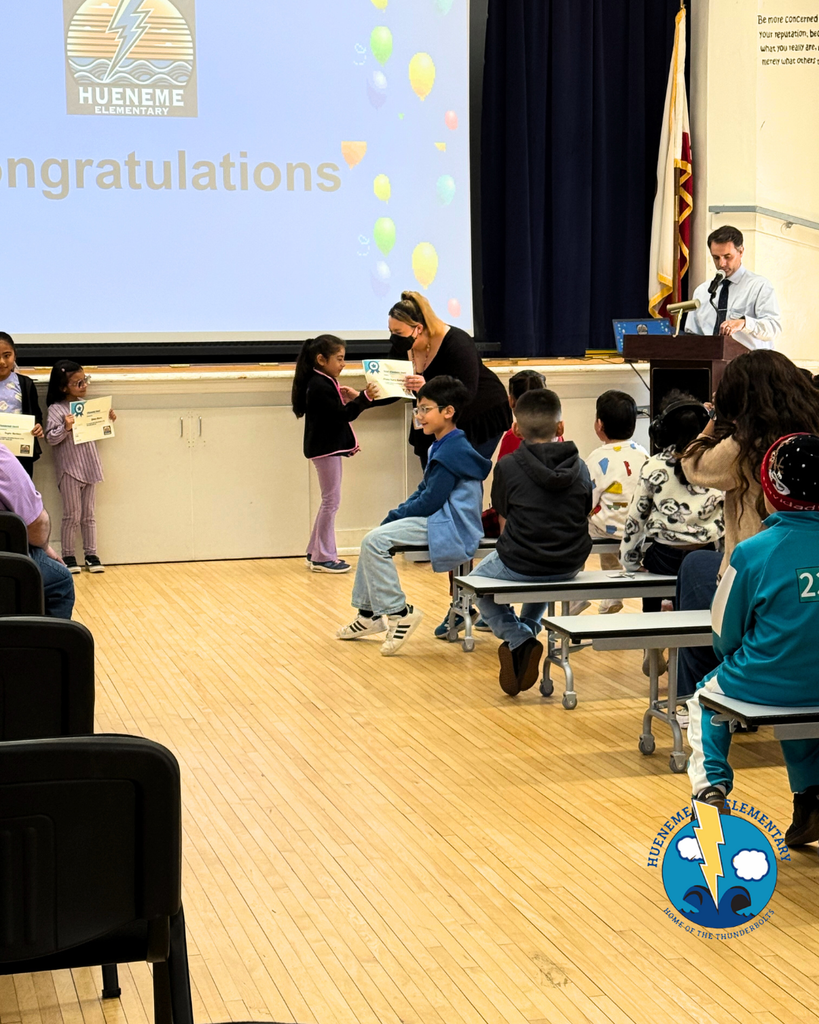 teacher gives kid  award