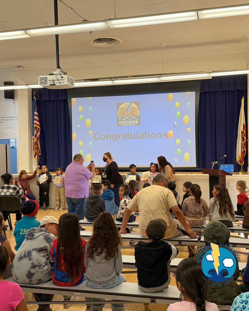students take picture with awards