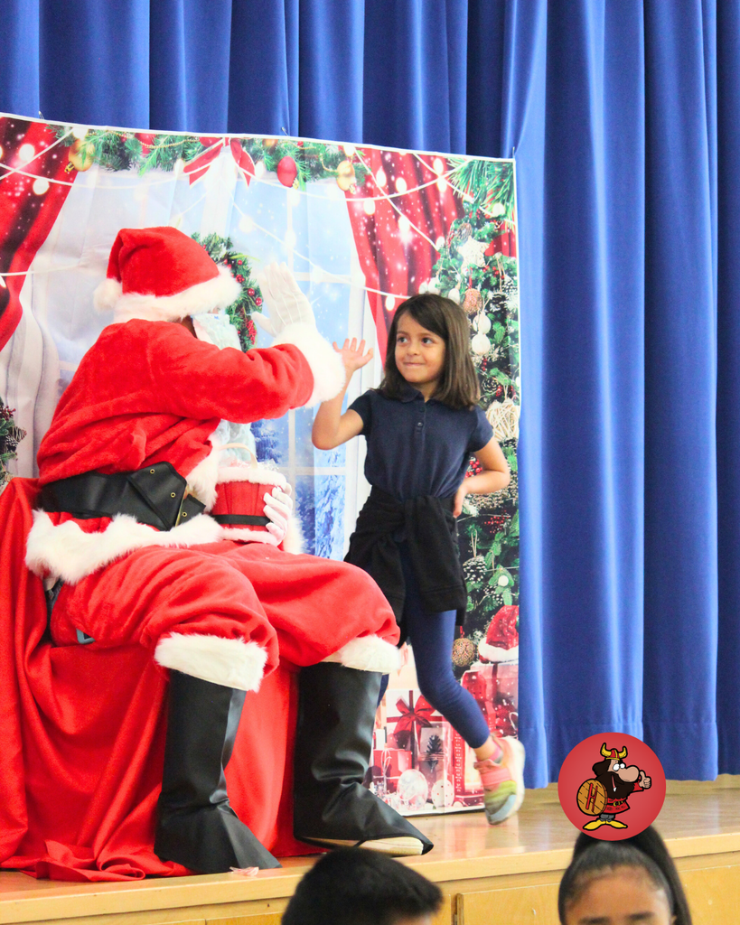 student giving santa a high five