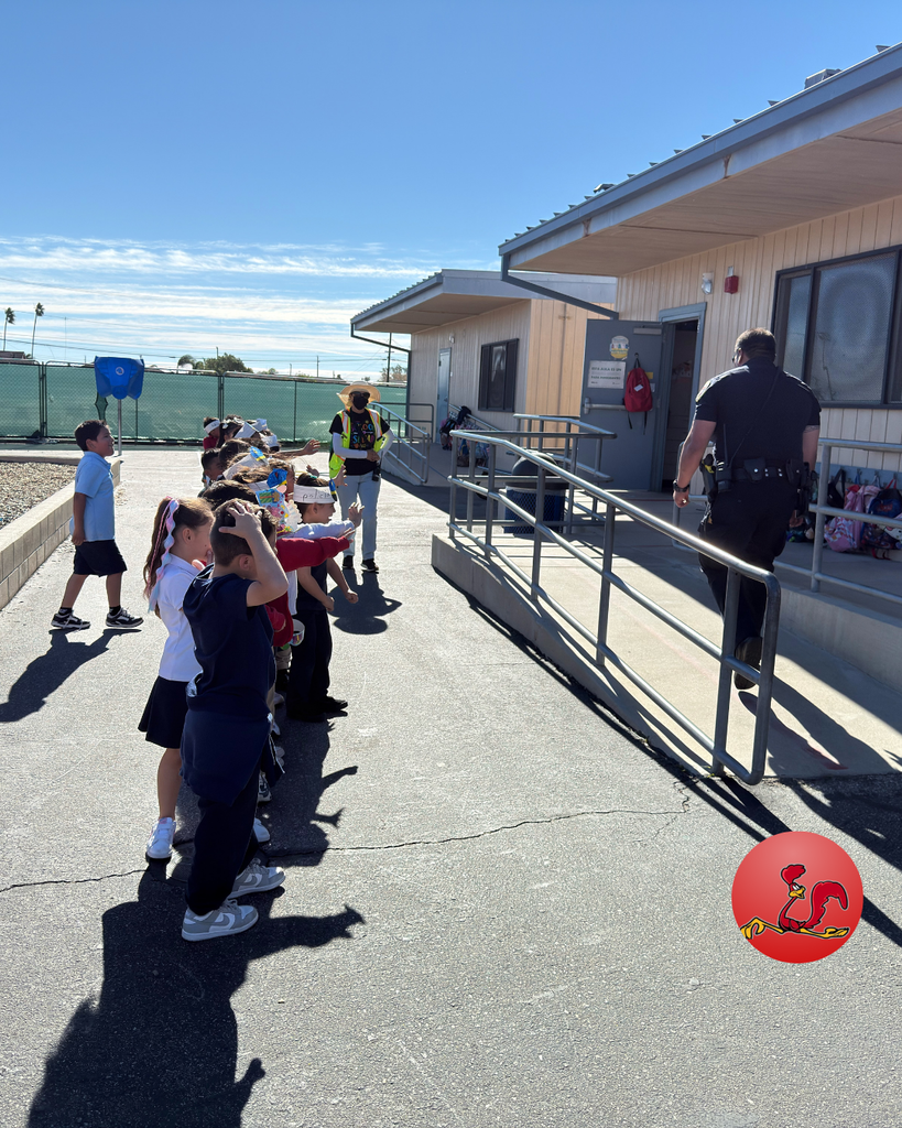 police officer answering students questions on community helper day