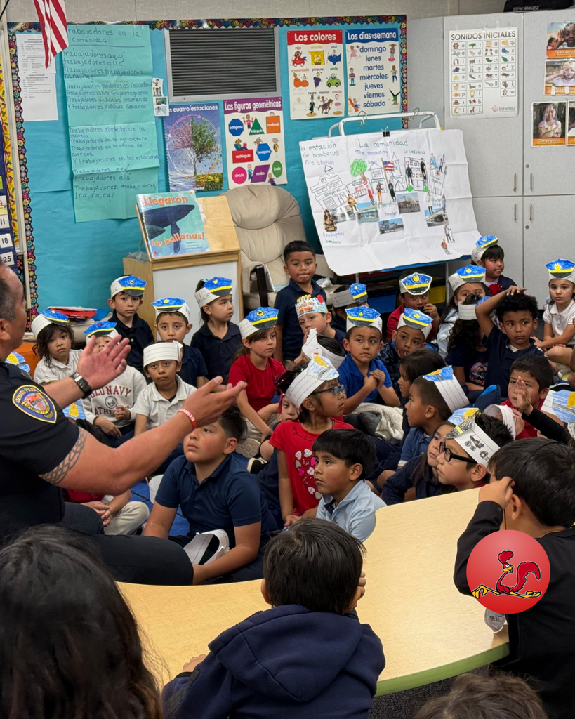 police officer answering students questions on community helper day
