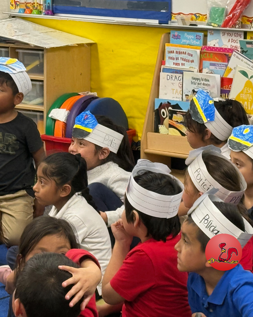 police officer answering students questions on community helper day