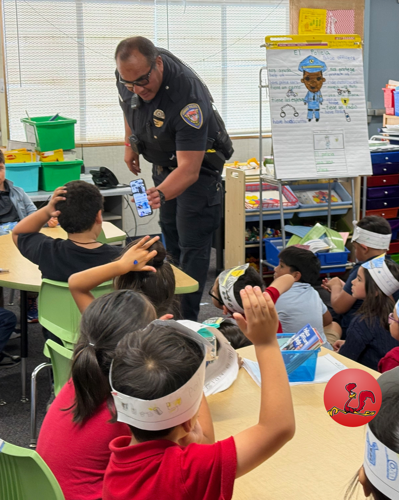 police officer answering students questions on community helper day