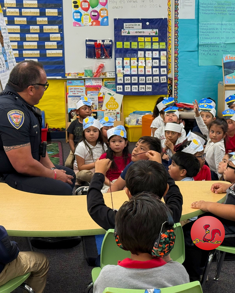 police officer answering students questions on community helper day