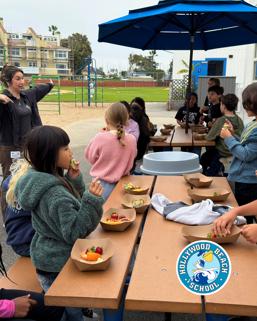 students enjoying different color fruits
