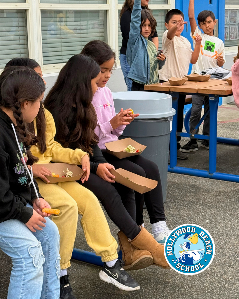 students enjoying different color fruits