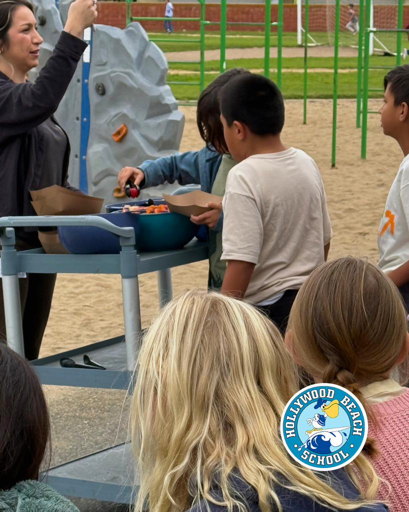 students enjoying different color fruits