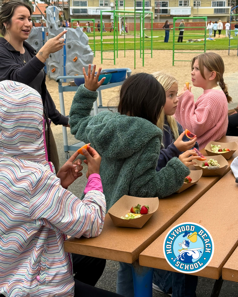 students enjoying different color fruits