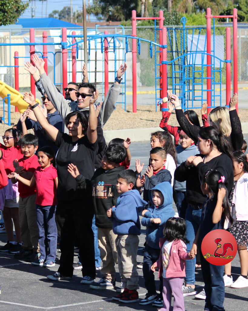 students performing dance routine while parents followed along