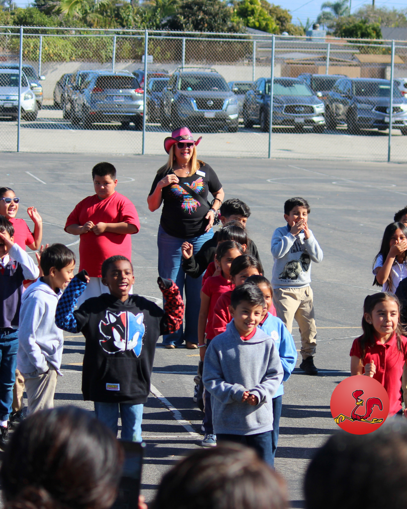 students performing dance routine while parents dance along