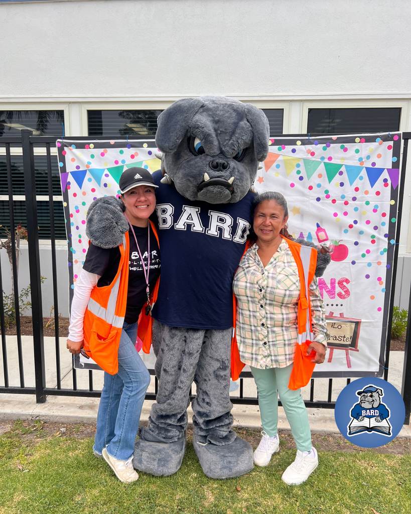 Two teachers with school mascot