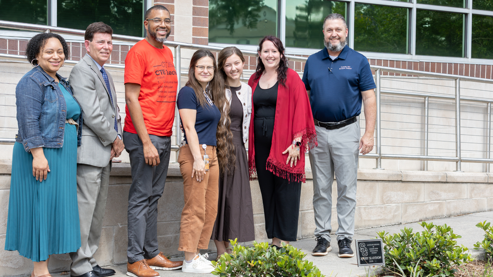 group of people standing together smiling