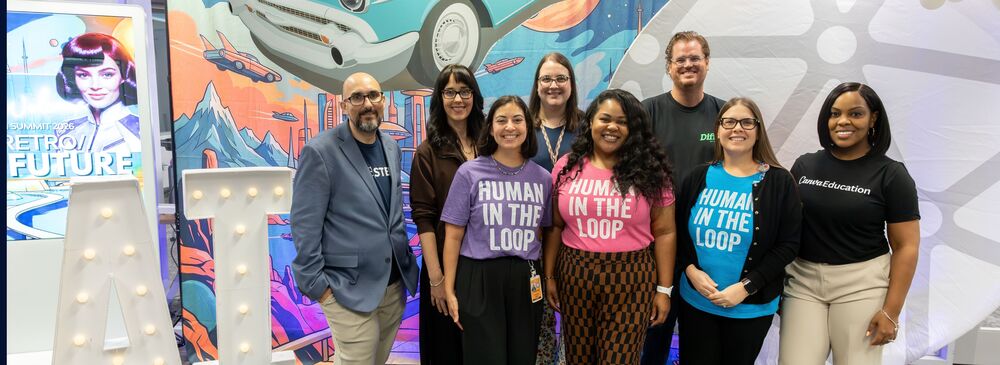 group of presenters posing together outside a backdrop and digital screen