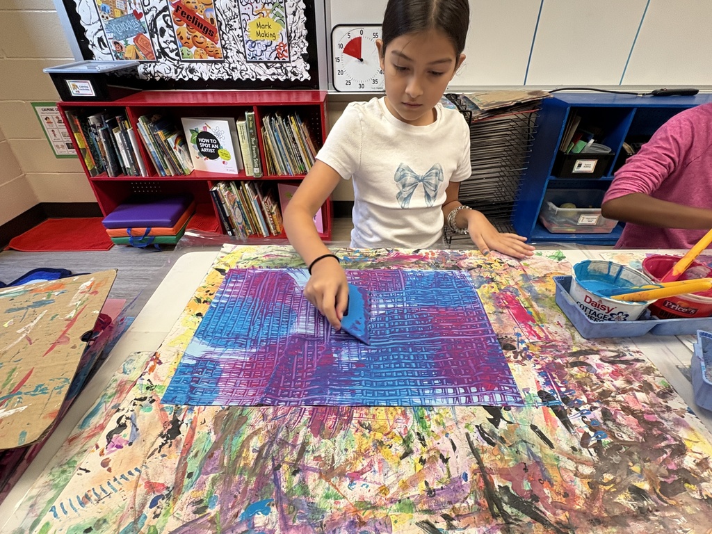 image of a student using art tools to mix colors