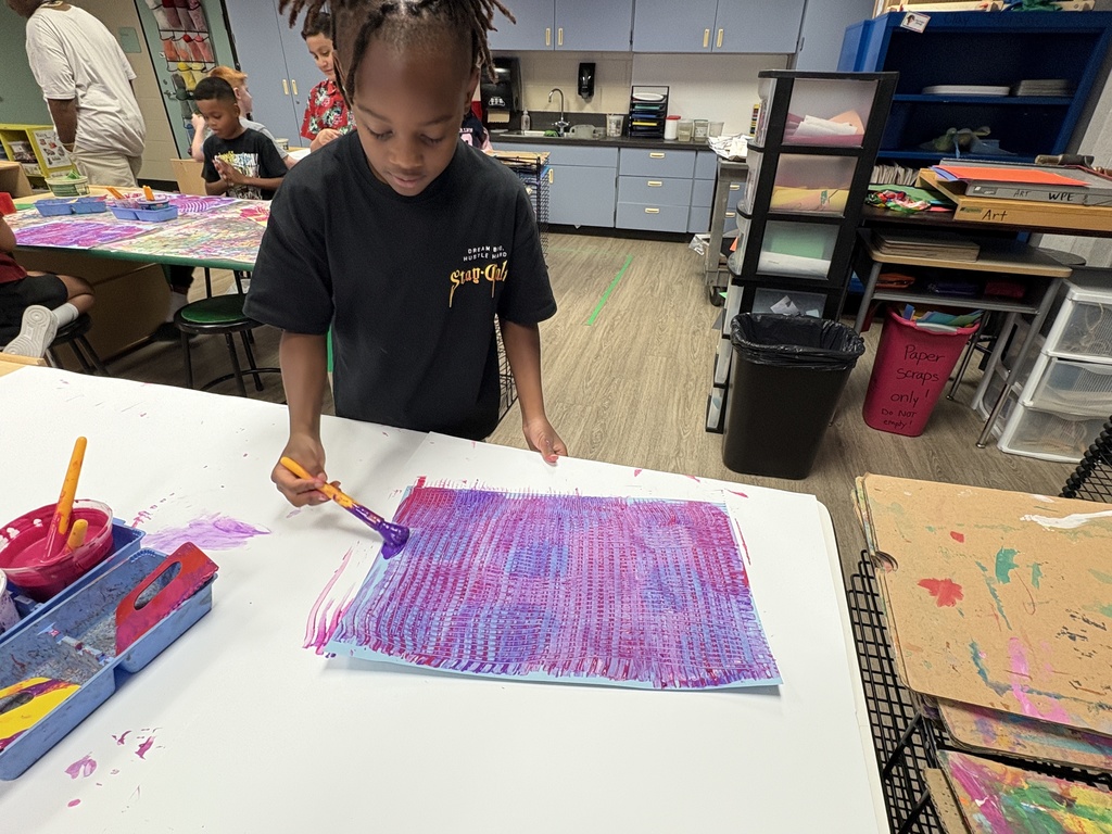 image of a student using art tools to mix colors