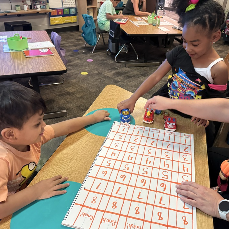 students playing math game with cars 