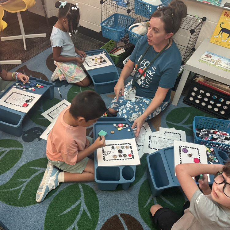 students and teacher on rug counting with buttons 