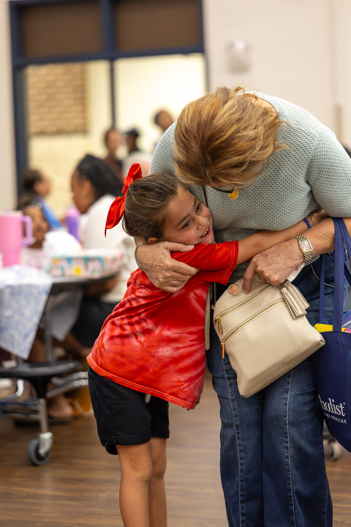 Grandparent luncheon kid hugging grandma