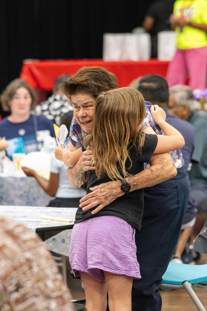 Grandparent luncheon kid hugging grandma