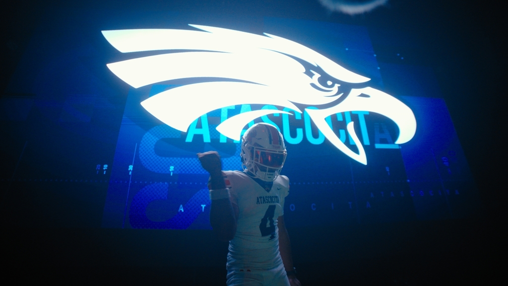 CJ Toney in font of LED screen